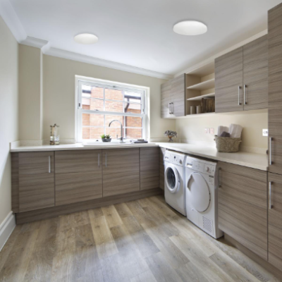 Image of a laundry room with a washer and dryer on Bay Lighting's Maryland commercial lighting website