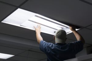 Image of a lighting technician working on a light fixture
